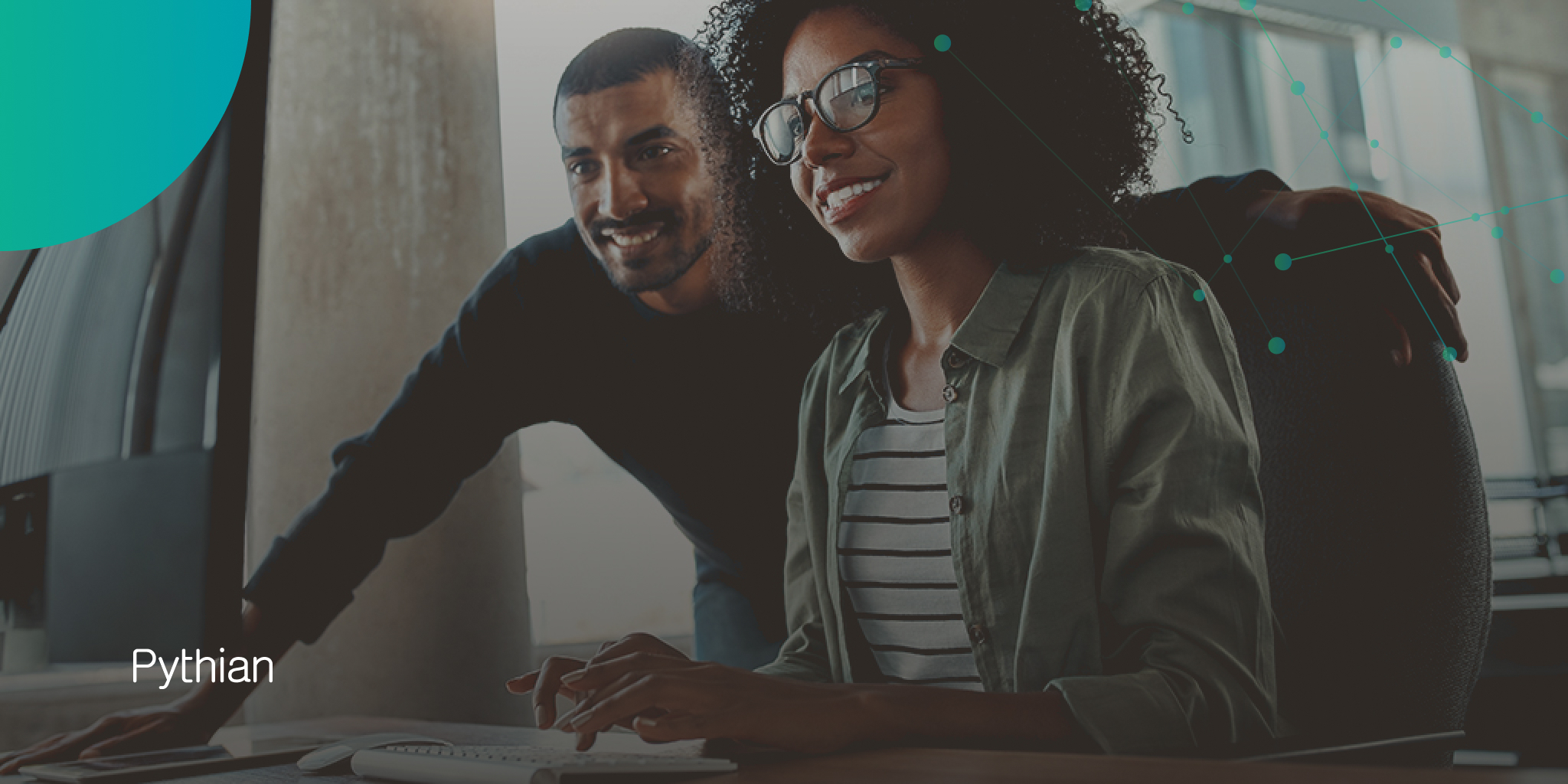 Man and woman looking at a computer screen, point of view is on their smiling faces.